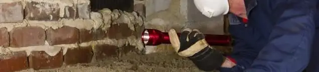 Pest control technician inspecting a crawl space for ant activity and entry points in Oklahoma City, OK