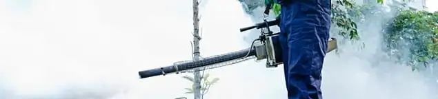 Pest control technician fogging an outdoor area for insect control in Oklahoma City, OK
