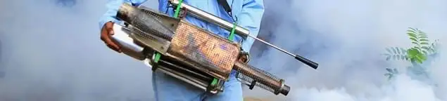 Fumigation technician using a fogger for deep pest treatment in Oklahoma City, OK